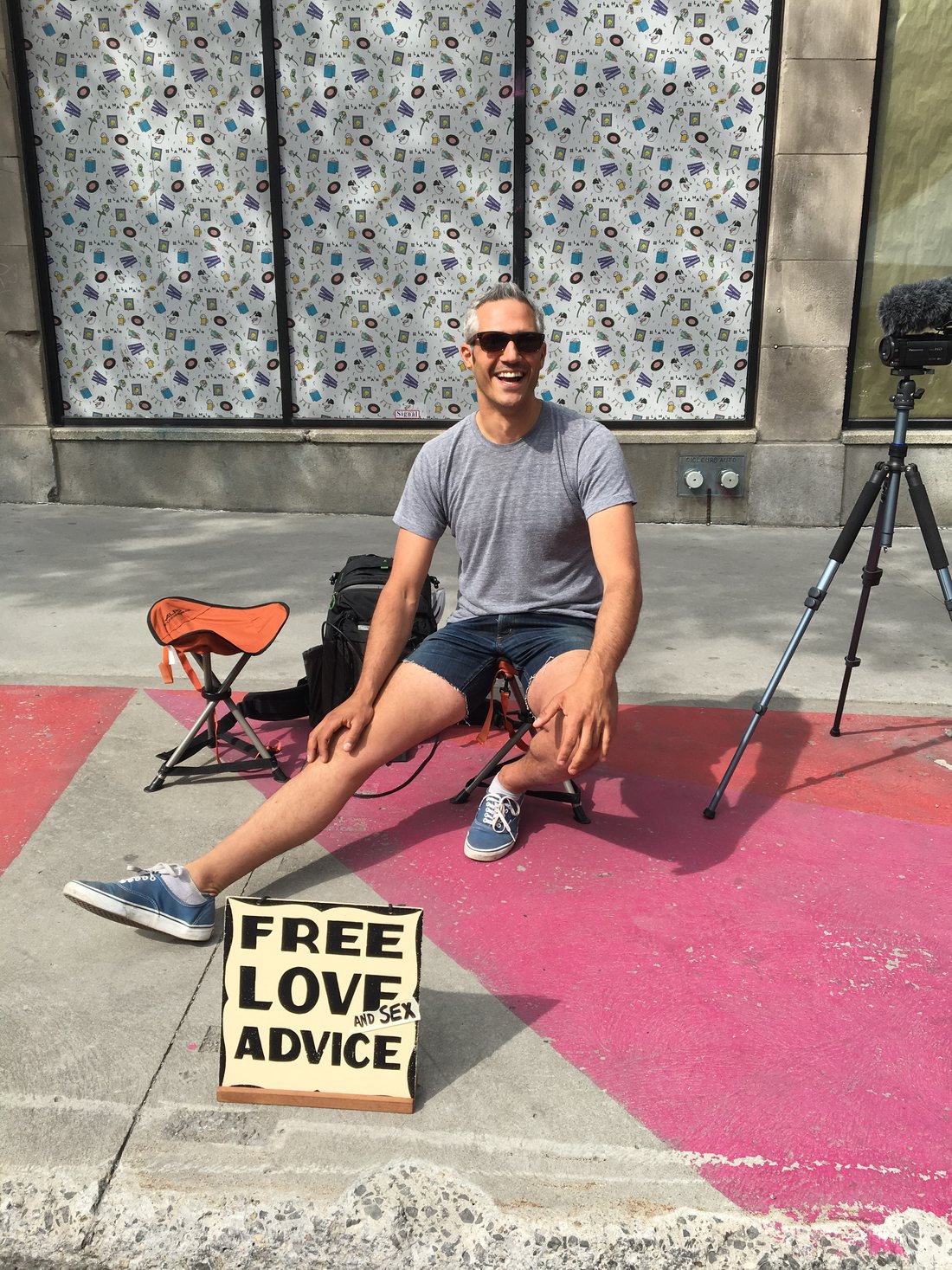 Shaun on a Montreal sidewalk with his Free Love and Sex Advice sign